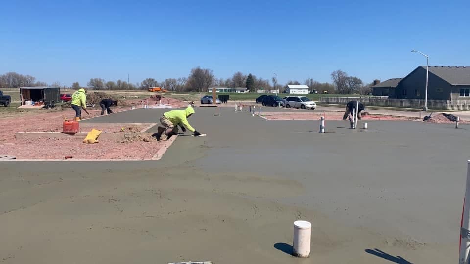One of our crew kneeling to finish the surface of a fresh slab