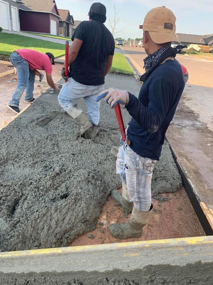 Our crew placing and working a load of fresh wet concrete into the forms by hand
