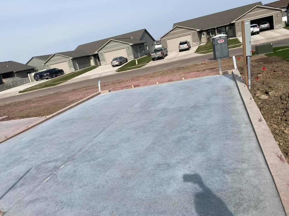 A finished driveway approach running up to a row of garages