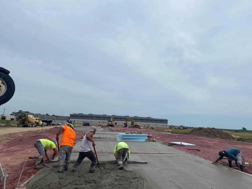 Our crew screeding and finishing a large freshly placed structural slab on a new commercial site