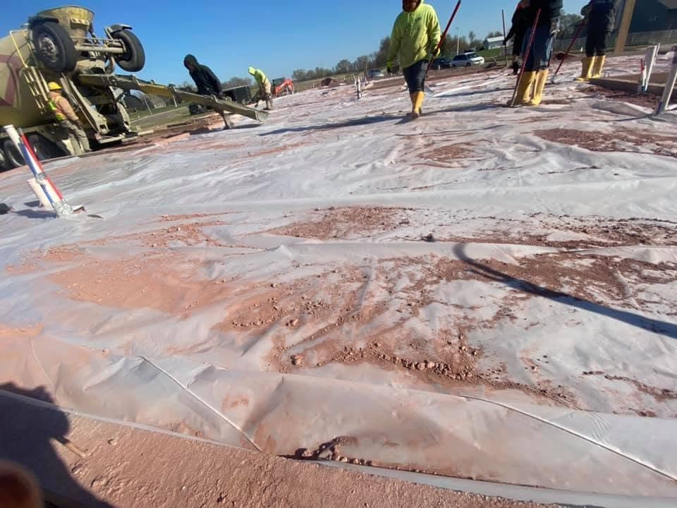 Our crew spreading and working wet concrete on pour day