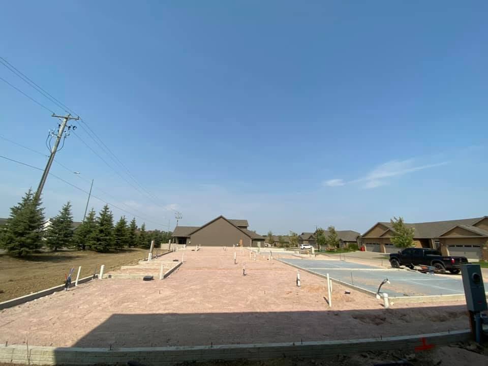 A formed and prepped Dakota lot, foundation walls and plumbing stub-ups set, ready for the pour